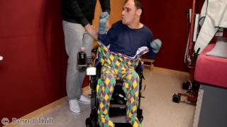 Strampler im Rollstuhl anziehen Guy with infantile cerebral palsy puts on romper suit  wheelchair [upl. by Atteugram]