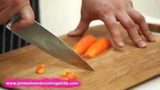 Chopping a carrot  Jamie Olivers Home Cooking Skills [upl. by Ardnassac97]