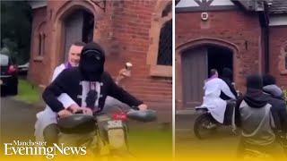 Priest shakes holy water from back of motorbike driven by masked youth at funeral in Salford [upl. by Finella288]