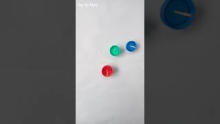 Use Waste Bottle Caps To Make Simple and Colourful Spinning Top shorts bottlecapcrafts diy [upl. by Antonie379]