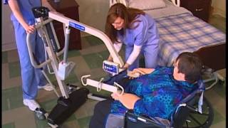 Transferring a patient from wheelchair to bed with a Reliant 600 and full body sling [upl. by Rance]