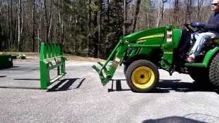 John Deere 2032R Swapping Pallet Forks to Bucket and Back [upl. by Delano90]