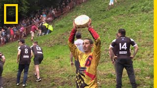 Watch a Downhill CheeseChasing Competition in Britain  National Geographic [upl. by Rust]