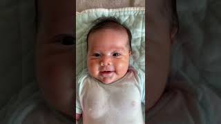 The video shows a closeup of a smiling baby wearing a blue onesie [upl. by Shah]