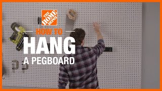 How to Hang a Pegboard  The Home Depot [upl. by Oinoitna]