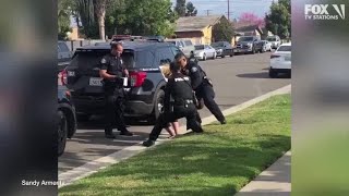 Police officers stop fellow officer punching handcuffed woman during arrest [upl. by Mairym68]